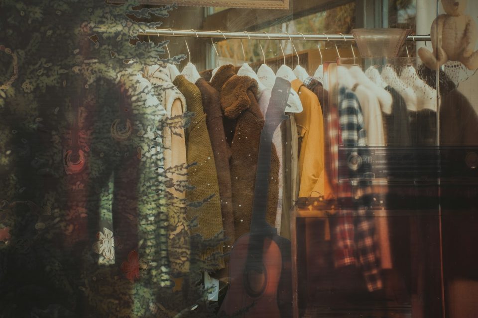 Clothes hanging on a rack with a reflection