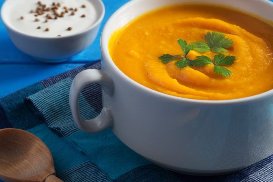 Creamy pumpkin soup with parsley and bread