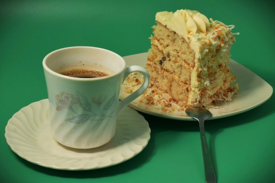 A slice of cake with a cup of coffee